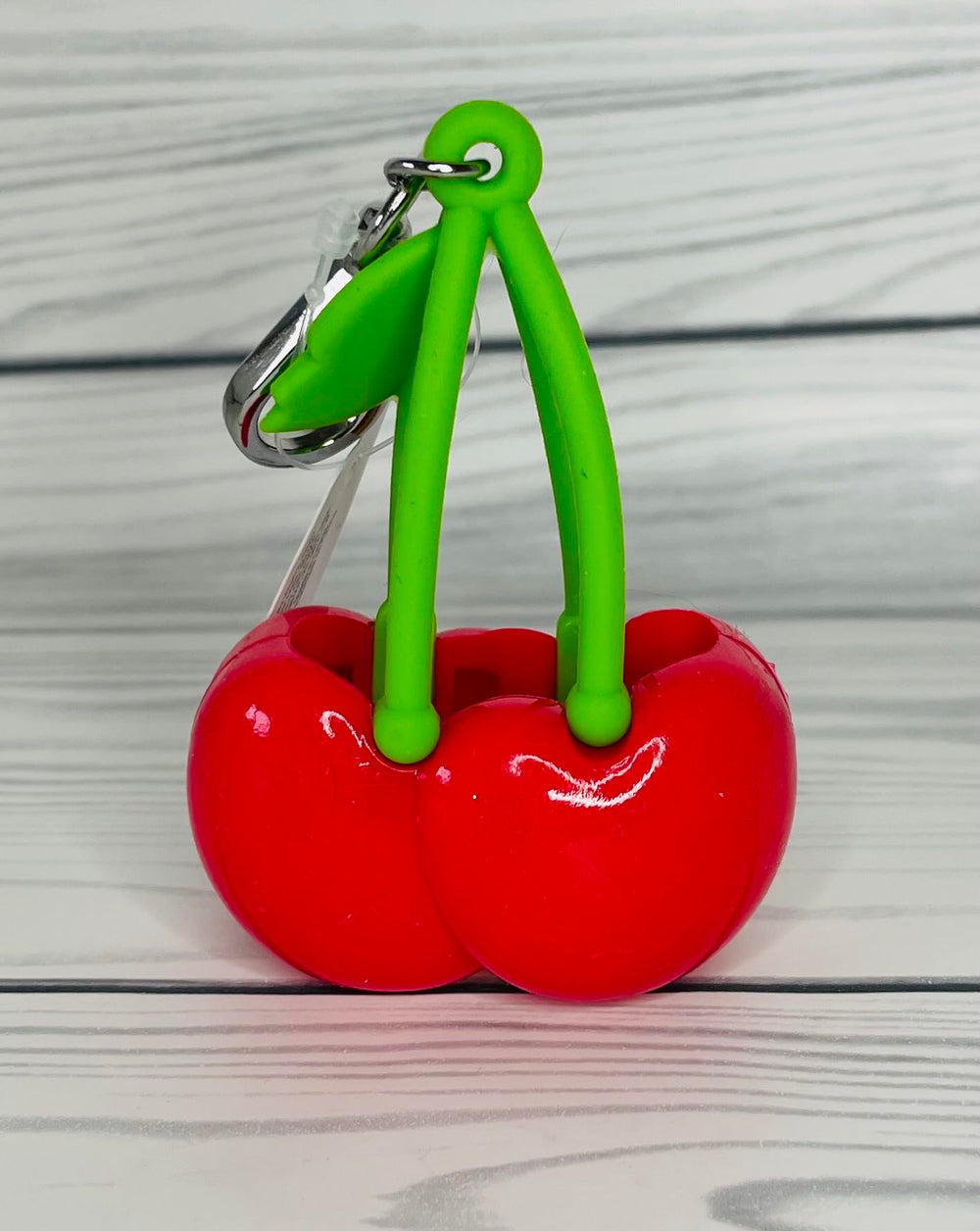 Bath & Body Works red cherries accessory detail helps keep sanitizer handy while commuting