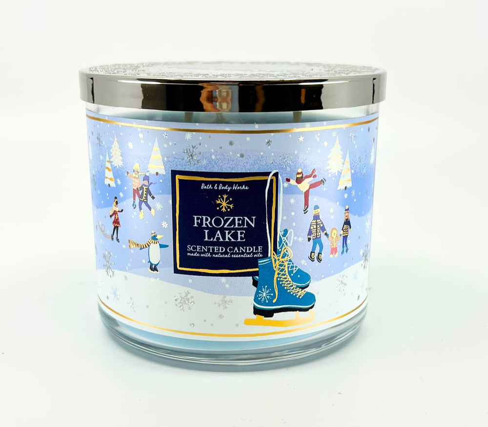Bath & Body Works White Barn 3-Wick Candle Frozen Lake jar glows warmly for cozy ambiance