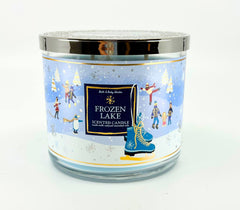 Bath & Body Works White Barn 3-Wick Candle Frozen Lake jar glows warmly for cozy ambiance