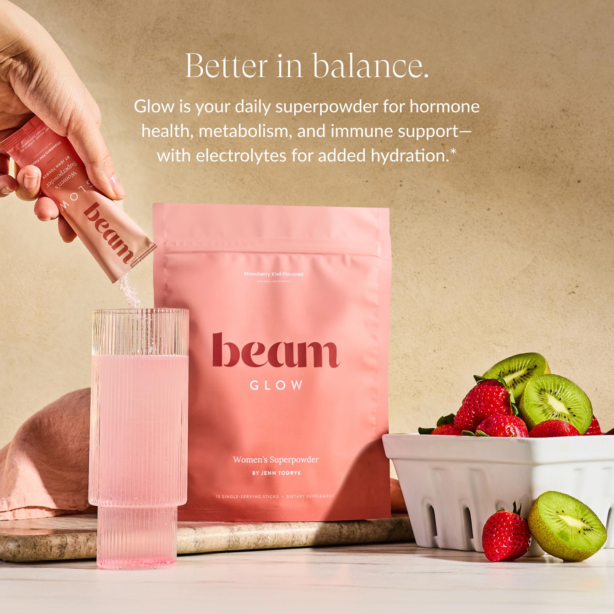 Beam Glow powder being scooped for daily hormone balance support.