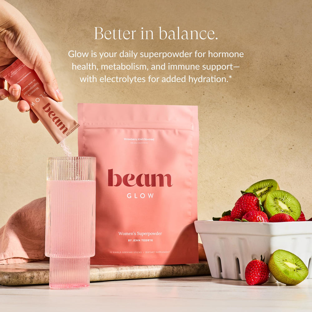 Beam Glow powder being scooped for daily hormone balance support.