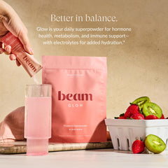 Beam Glow powder being scooped for daily hormone balance support.