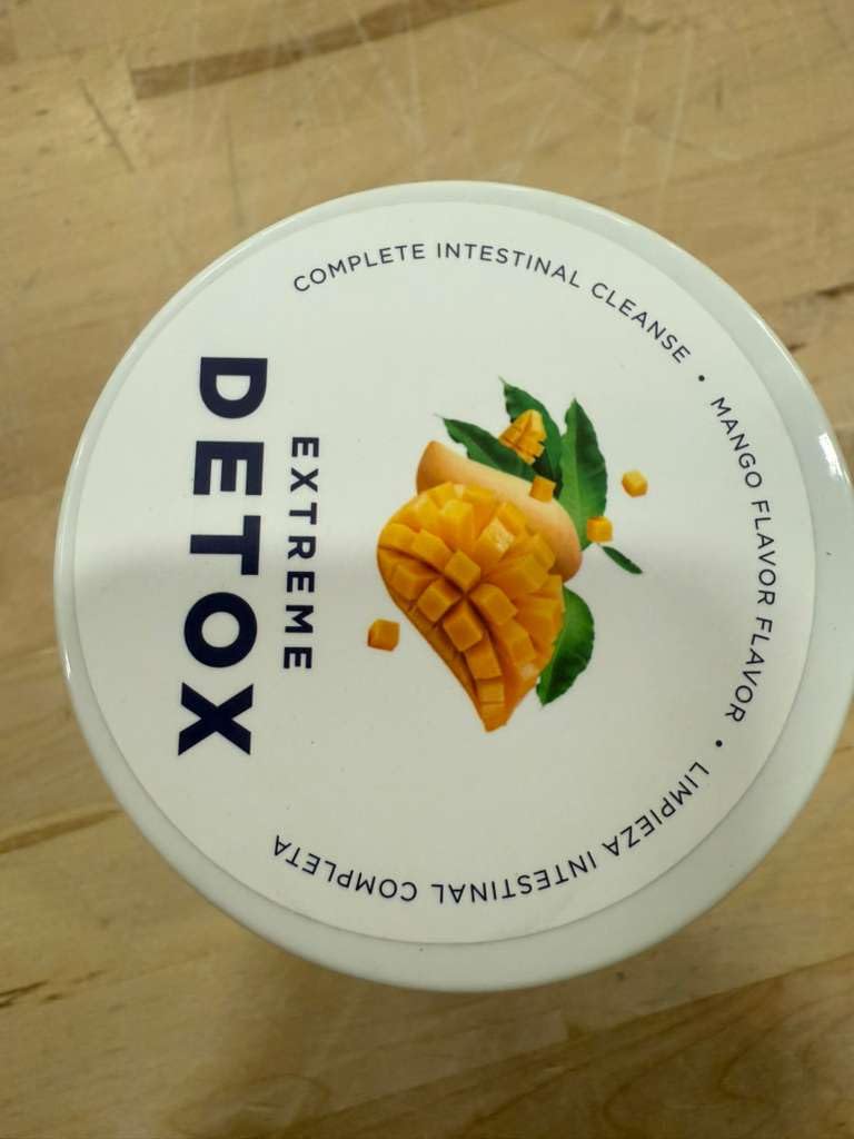 Serving pour of Bella All Natural Detox Powder Mango drink.