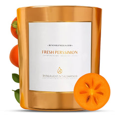 Benevolence LA Fresh Persimmon wood wick candle glowing in a festive setting for cozy holidays.
