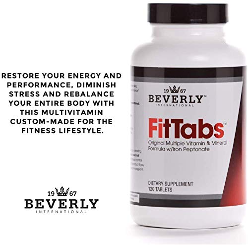Beverly International FitTabs bottle beside glass on kitchen counter for daily fitness support.