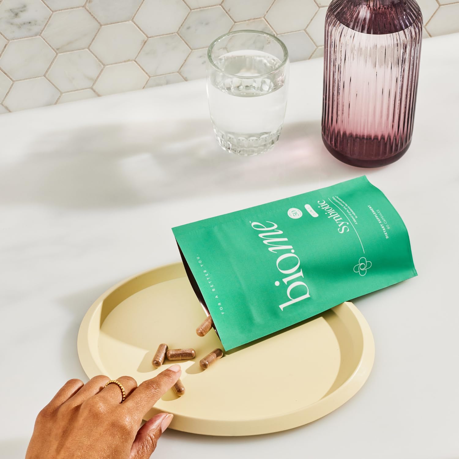 Bio.me Synbiotic bottle against neutral background suggesting bloating relief.
