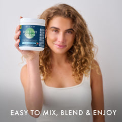 BIOHM Digestive Greens glass with Berry powder dissolving, ready to drink.
