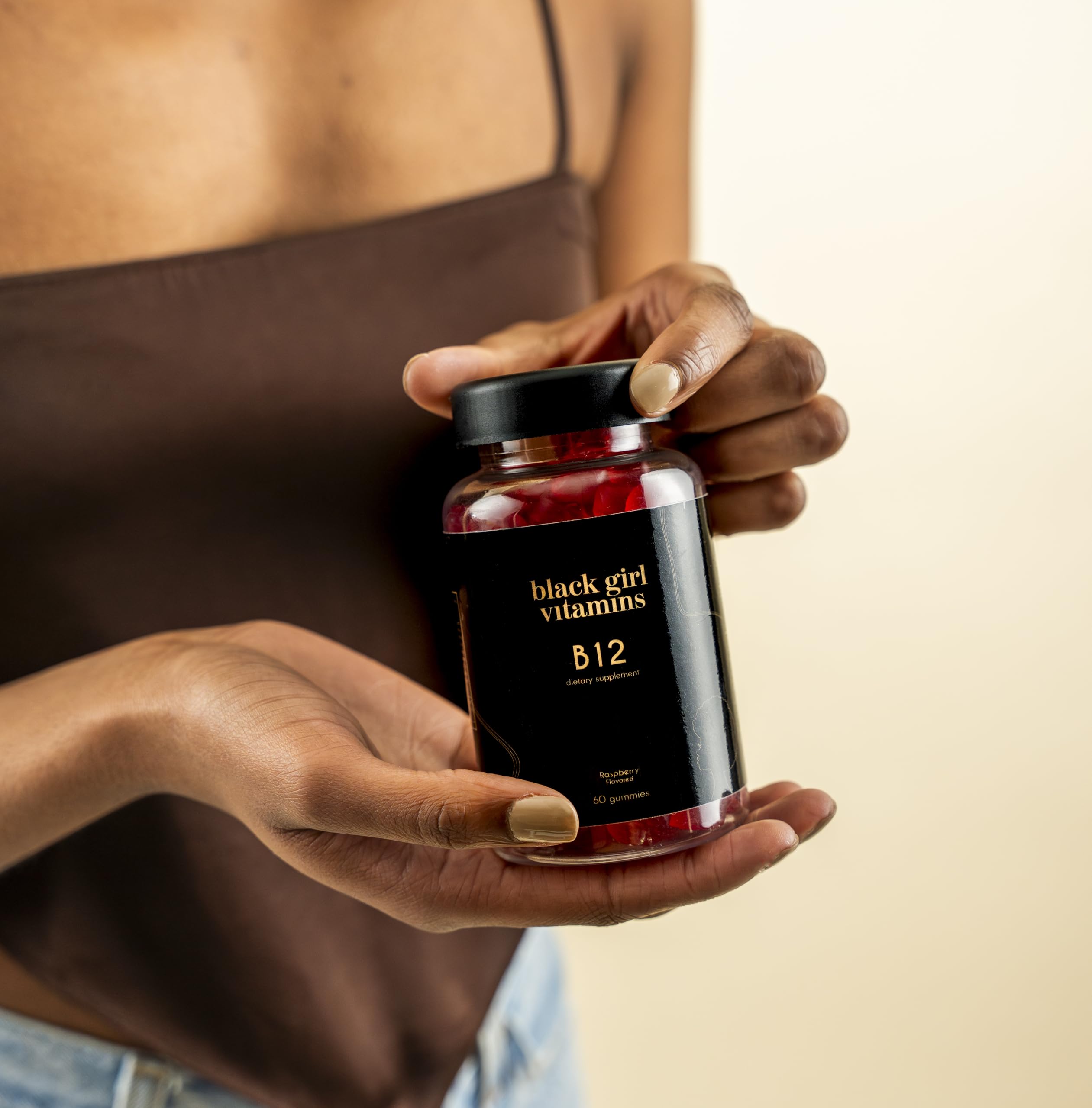 Person taking Black Girl Vitamins B12 gummy as part of daily routine