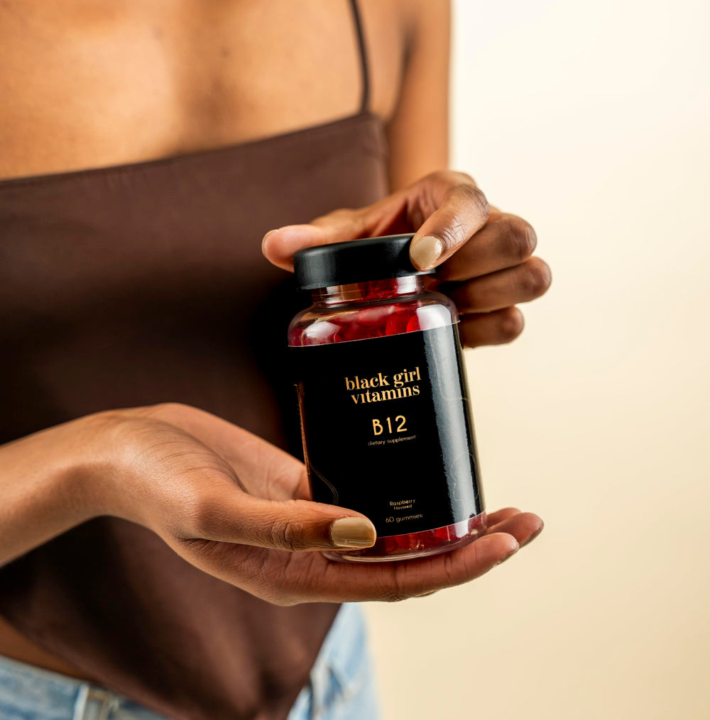 Person taking Black Girl Vitamins B12 gummy as part of daily routine