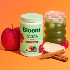 Bloom Nutrition greens powder jar labeled with 30+ ingredients and flavor