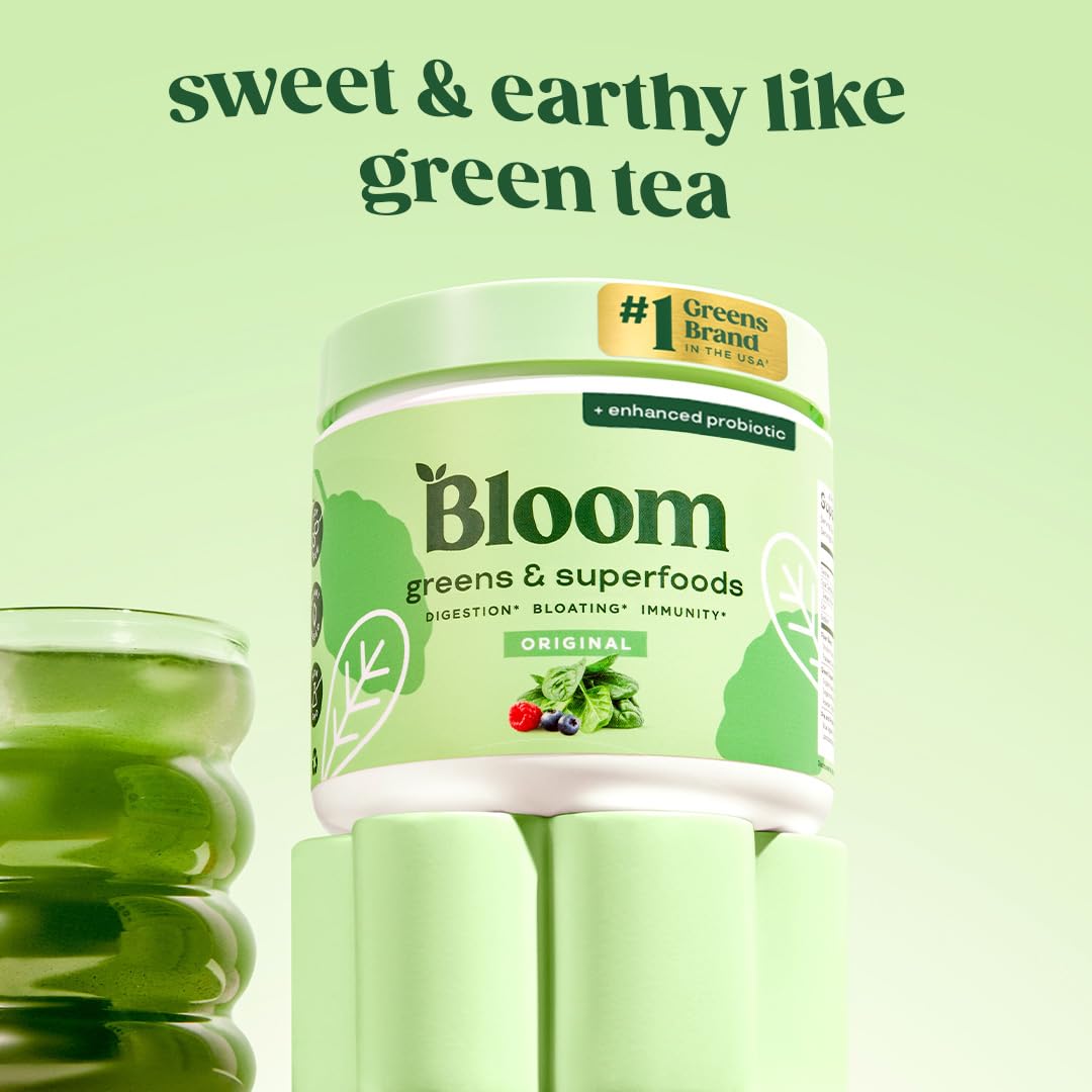 Bloom Nutrition greens powder scoop pouring into glass for easy mixing