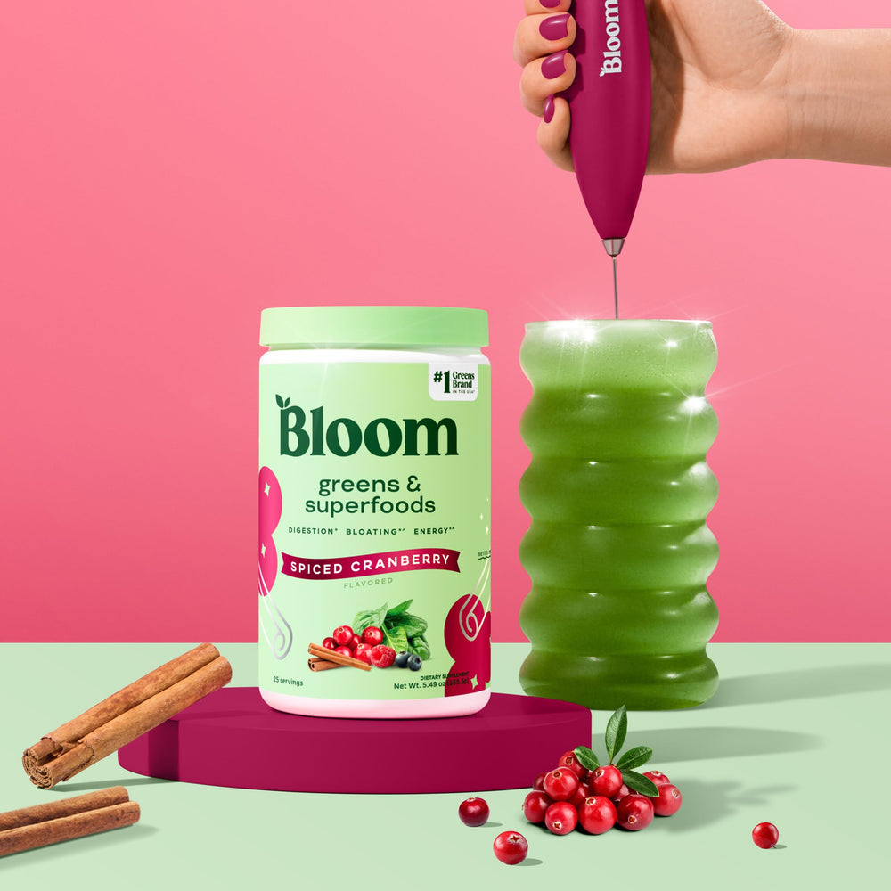 Bloom Nutrition Greens Powder scoop in use for daily energy and nutrition