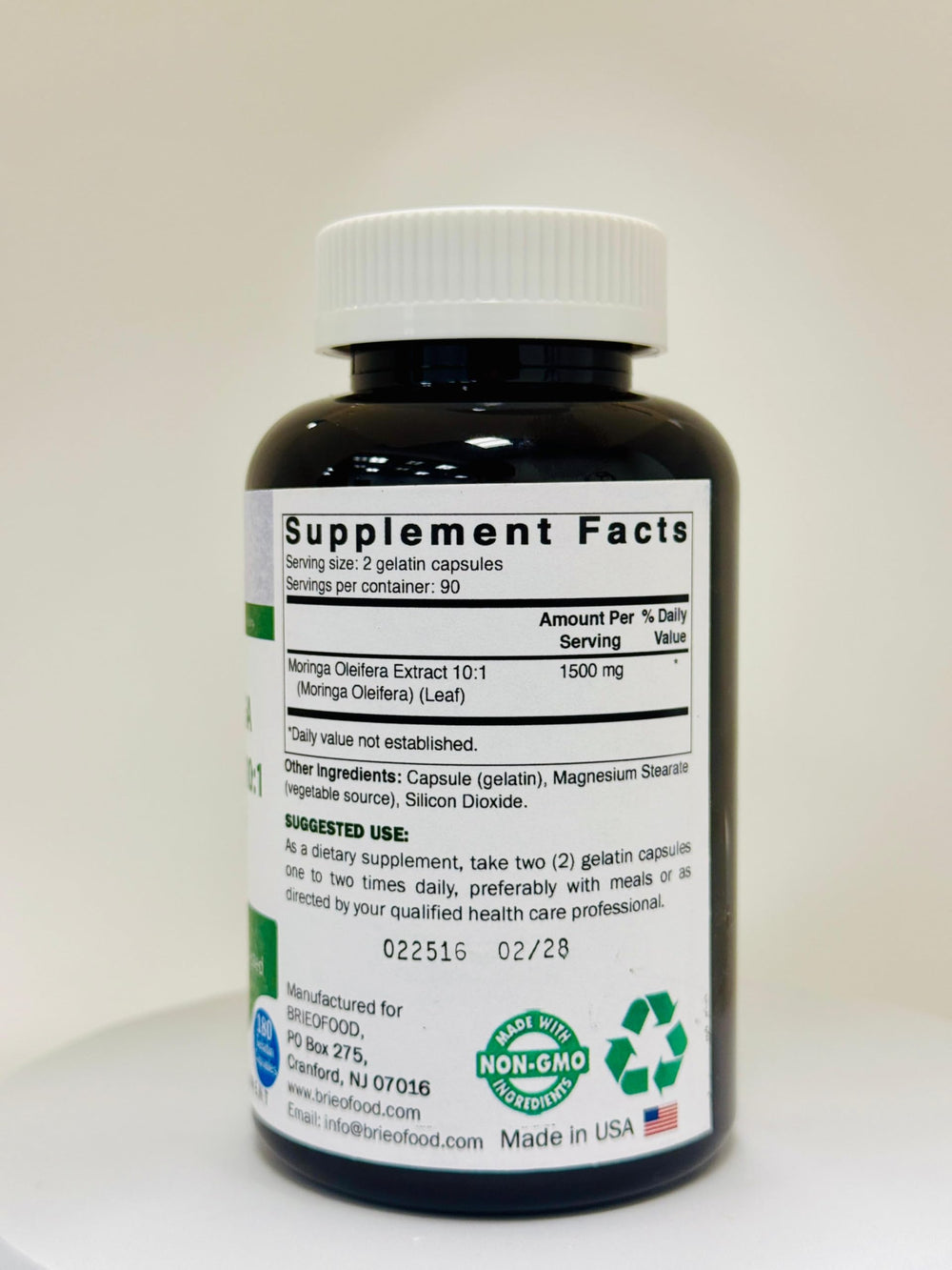 Brieofood Moringa leaves and bottle on a clean surface