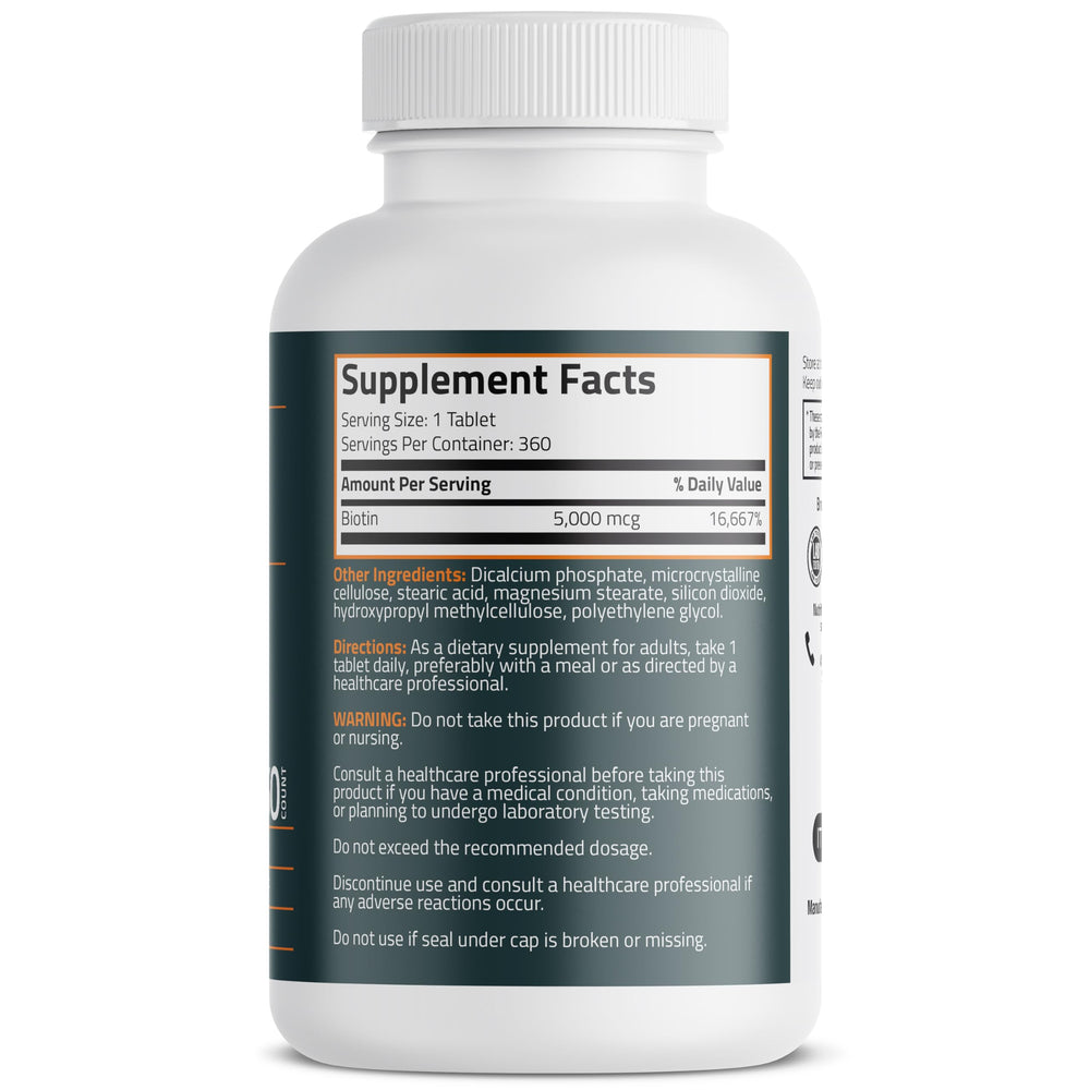 A hand holds Bronson Biotin 5,000 mcg mini tablet for convenient daily use.