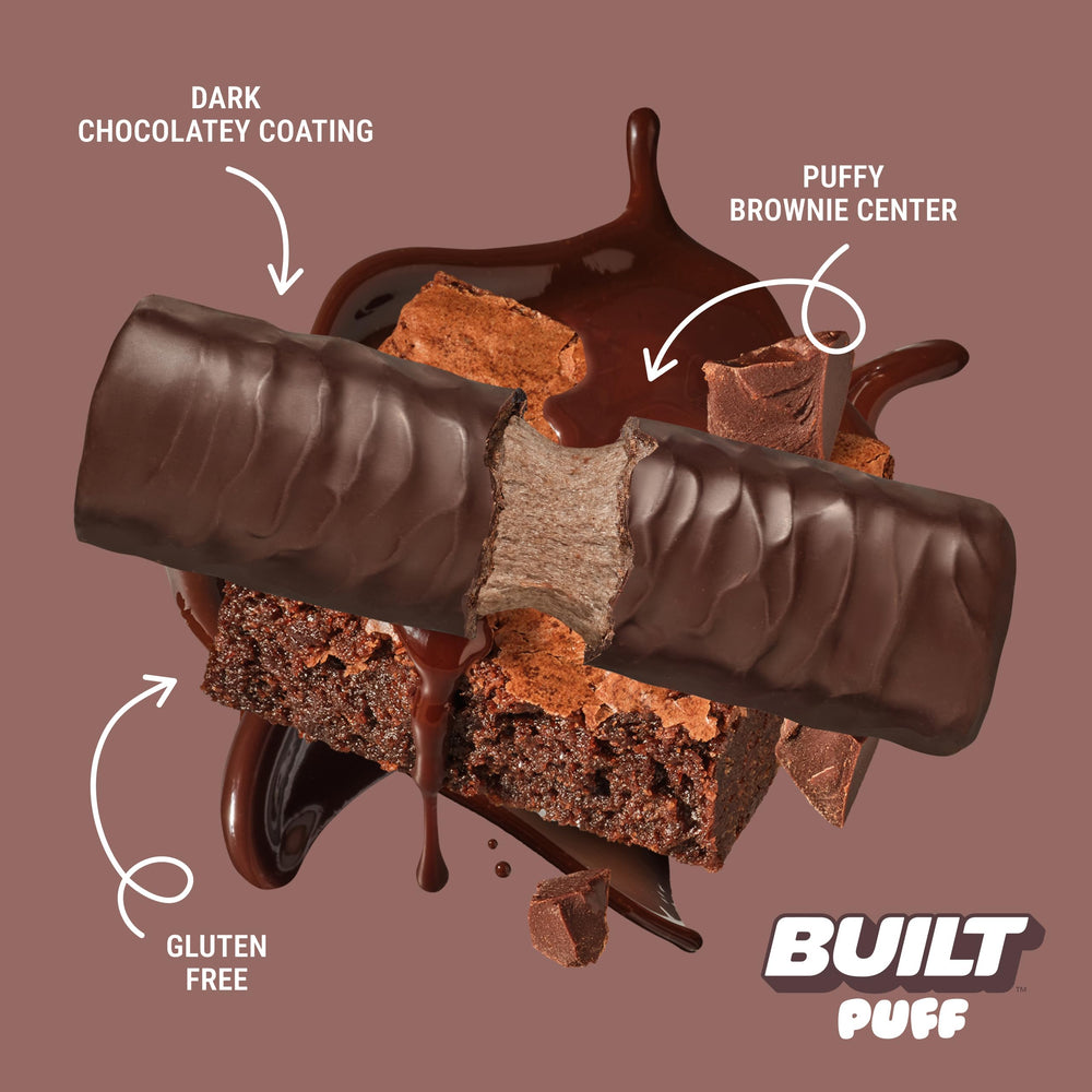 Hand holds Built Bar Puff Brownie Batter bar for quick protein on the move.