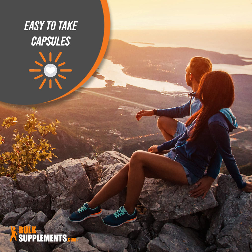 BulkSupplements caffeine capsules in hand for portable energy on the go.