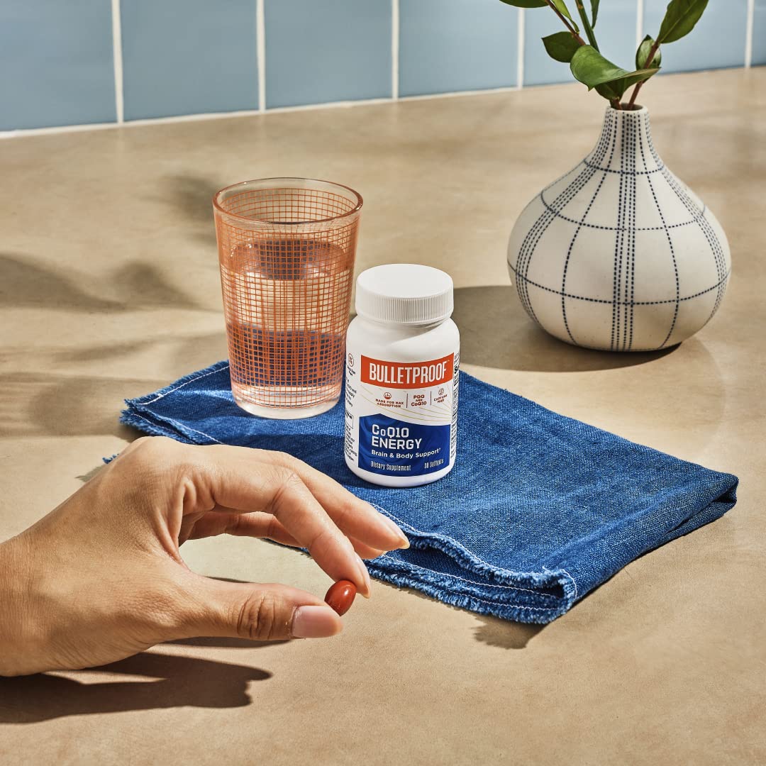 Softgel capsule and bottle with water, showing easy daily dosage
