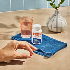 Softgel capsule and bottle with water, showing easy daily dosage
