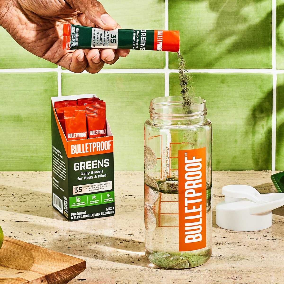 Bulletproof Greens Packets glass-mixed beverage with pineapple flavor.