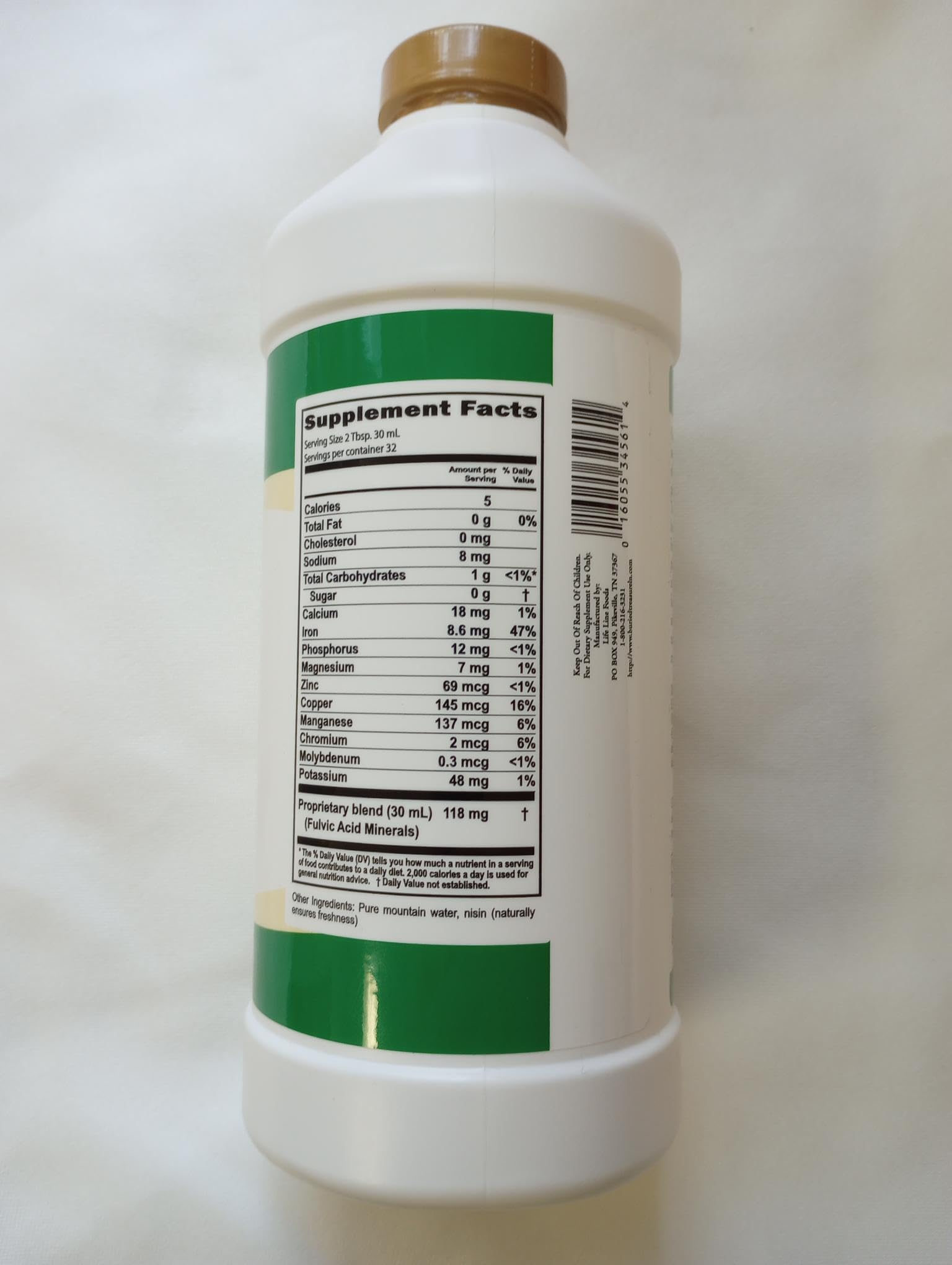 Buried Treasure Liquid Advantage Fulvic Minerals being poured into a glass for mixing.