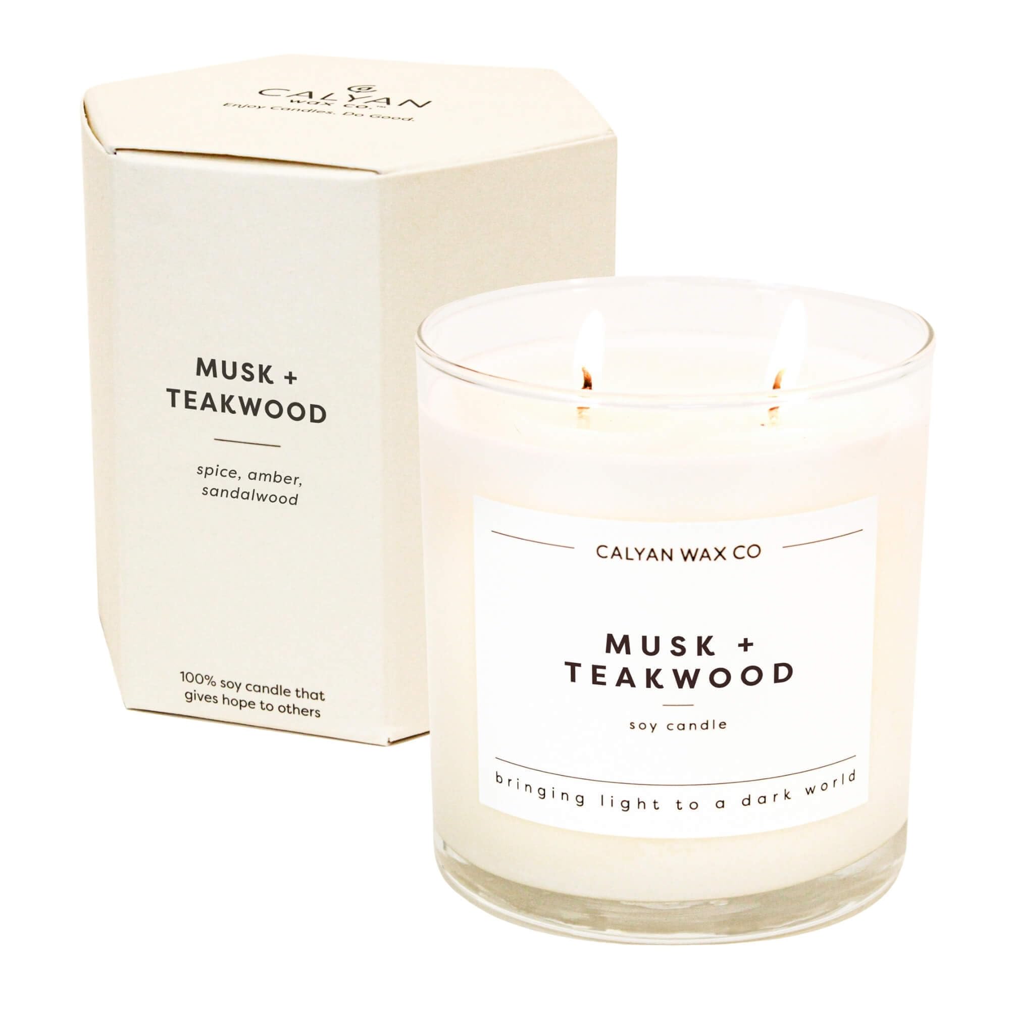 Calyan Musk Teakwood 2-Wick Candle in a glass jar for a warm, inviting ambiance.