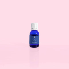 Capri Blue Blue Jean bottle closeup showing citrus-musk-patchouli notes for living rooms