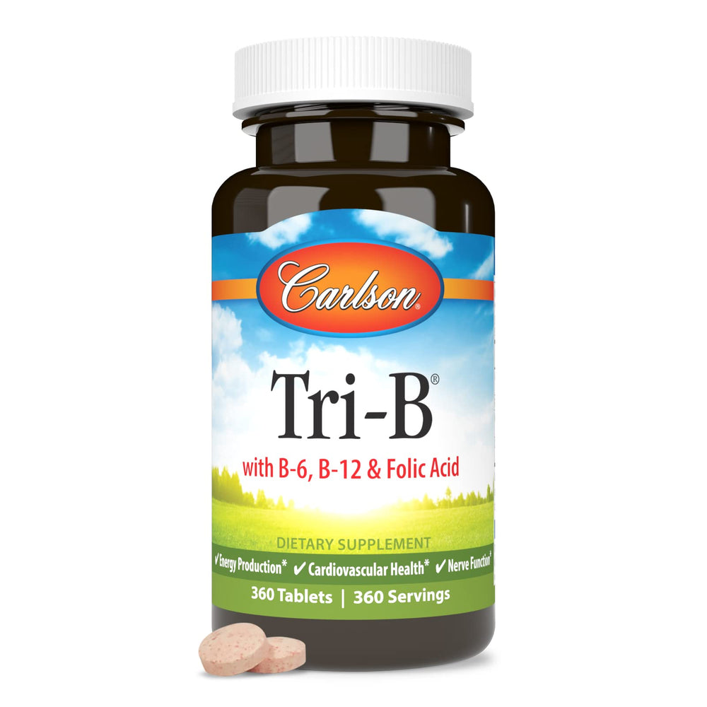 Carlson Tri-B bottle with tablets beside glass for daily health routine.