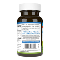Close-up of zinc tablet with nutrition panel indicating 15 mg dosage for daily wellness.