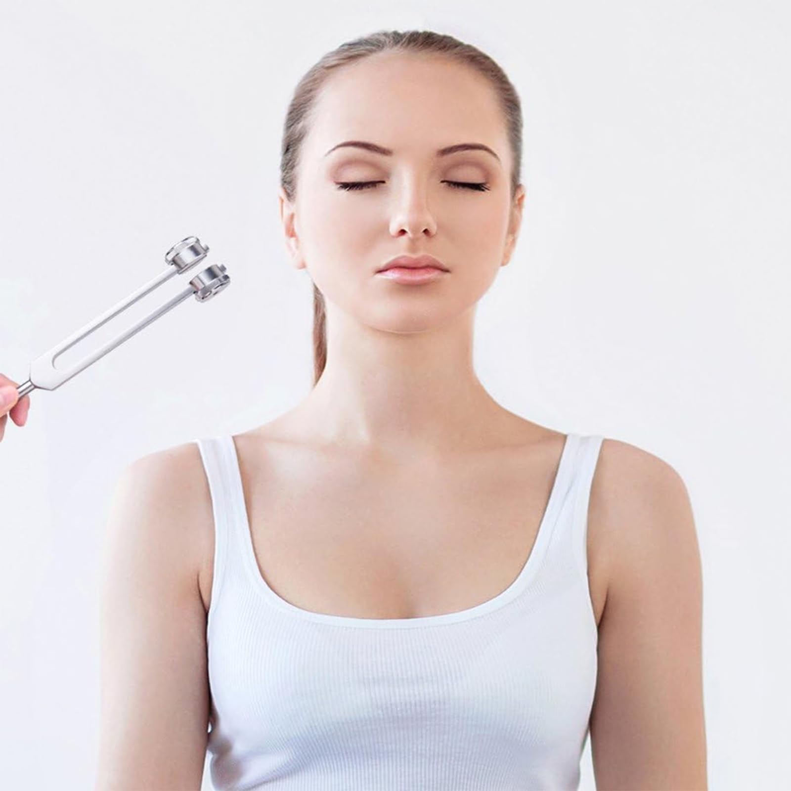CBCJIEHUXL tuning fork placed on the chest area for calming vibrations.