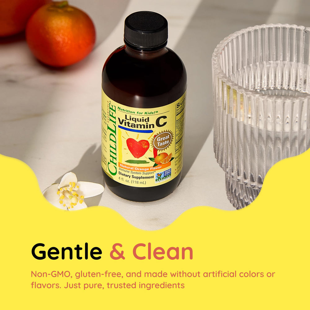 Glass with vitamin C drops demonstrates simple daily use for families