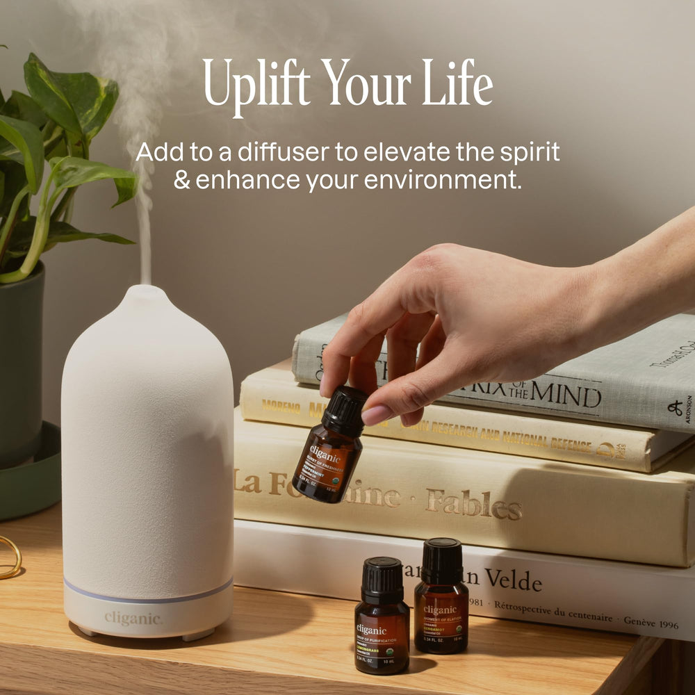 Cliganic lemon essential oil bottle for fresh fragrance in diffusers and cleaners.