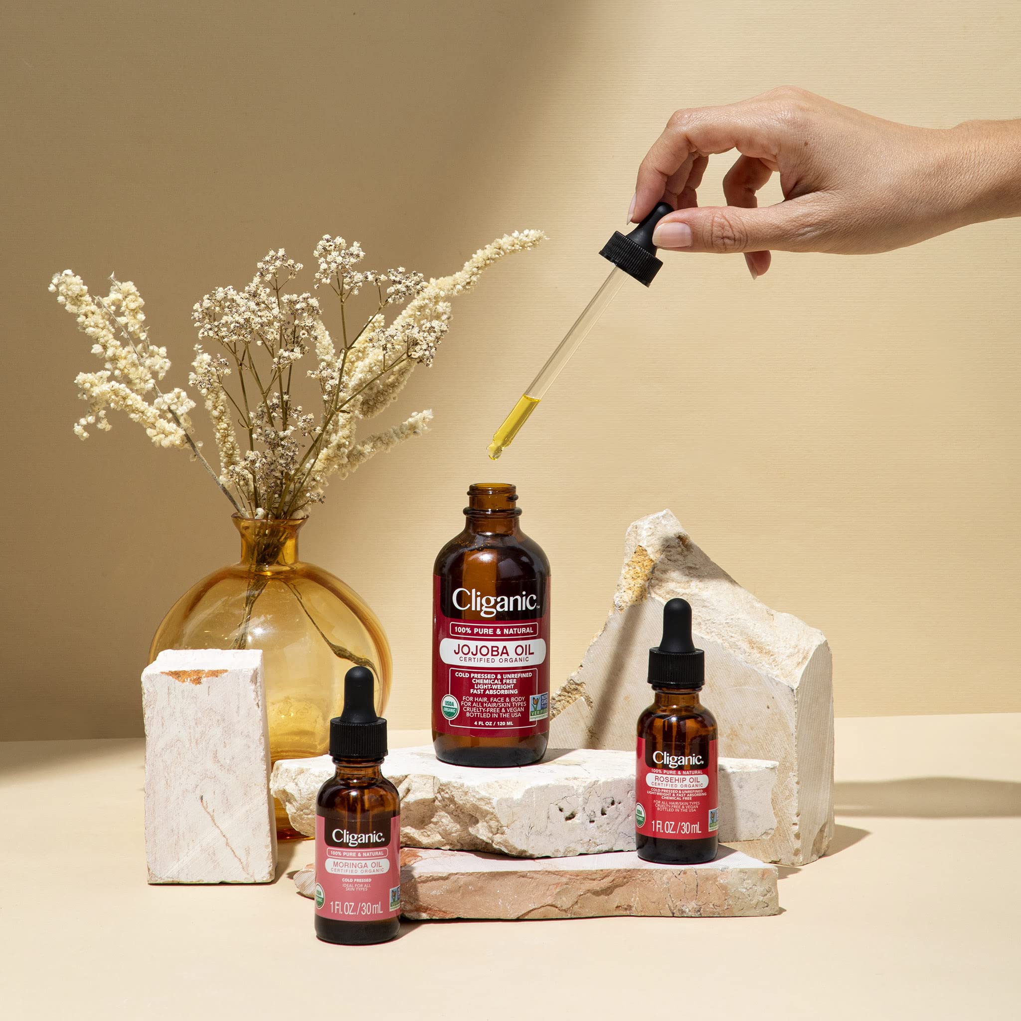 Cliganic Moringa Oil bottle on wooden surface signaling sustainable sourcing and vegan cruelty-free.