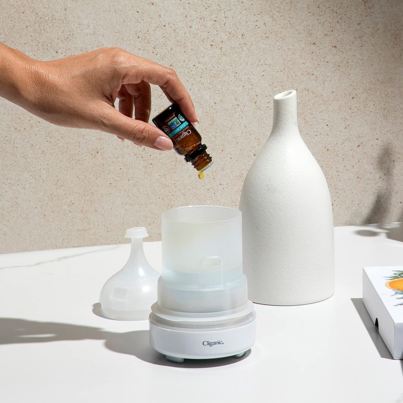 Cliganic Palmarosa oil with wooden diffuser in natural setup