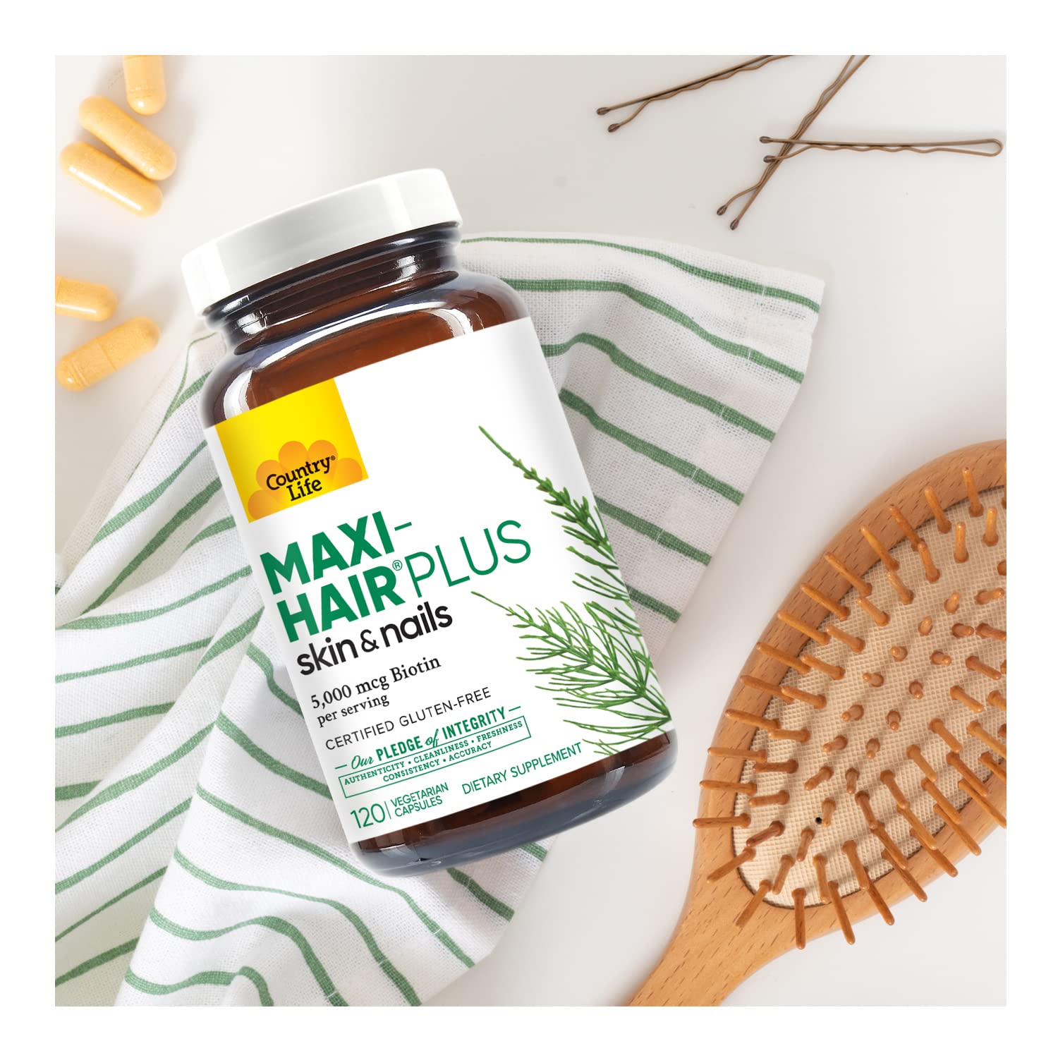 Country Life Maxi-Hair Plus bottle and capsules arranged for routine