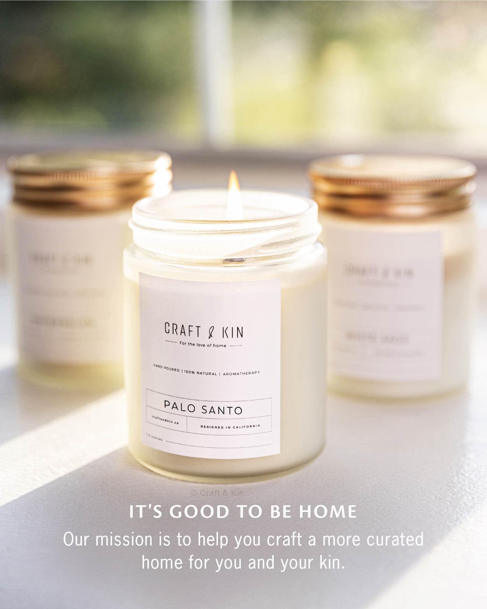 Craft & Kin Palo Santo candle lit, casting warm glow