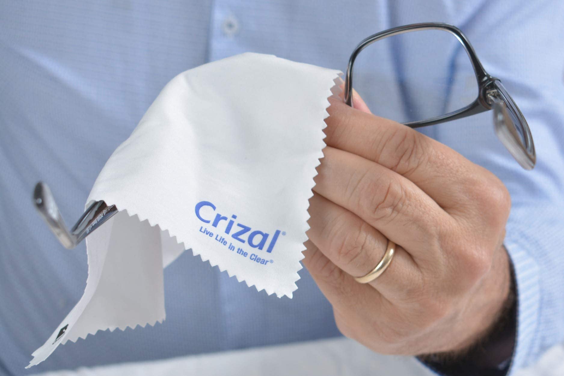 Crizal cloth cleaning a smartphone screen for coated surface care