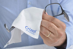 Crizal cloth cleaning a smartphone screen for coated surface care
