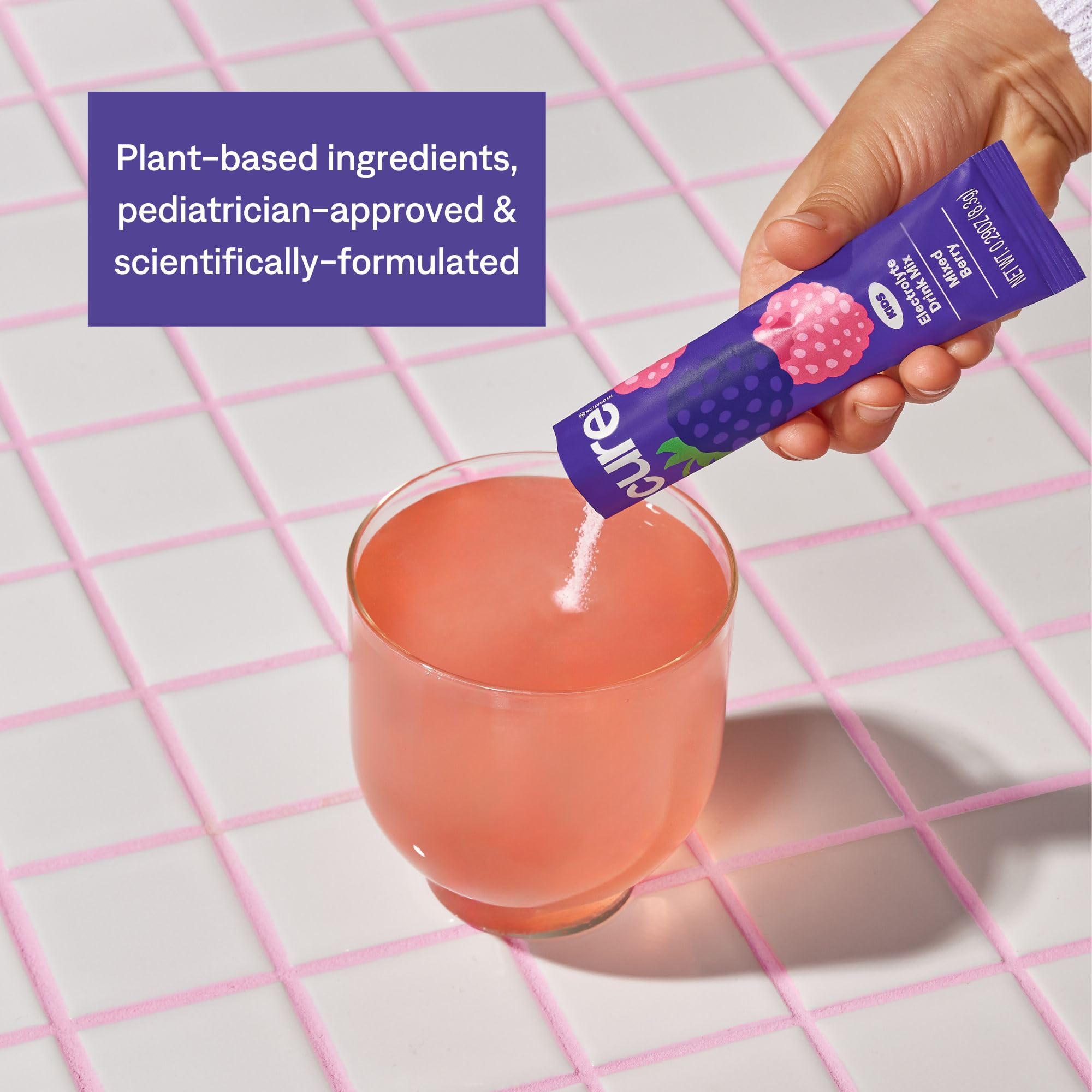 Cure Hydration glass of the mixed berry drink ready for sip after activity