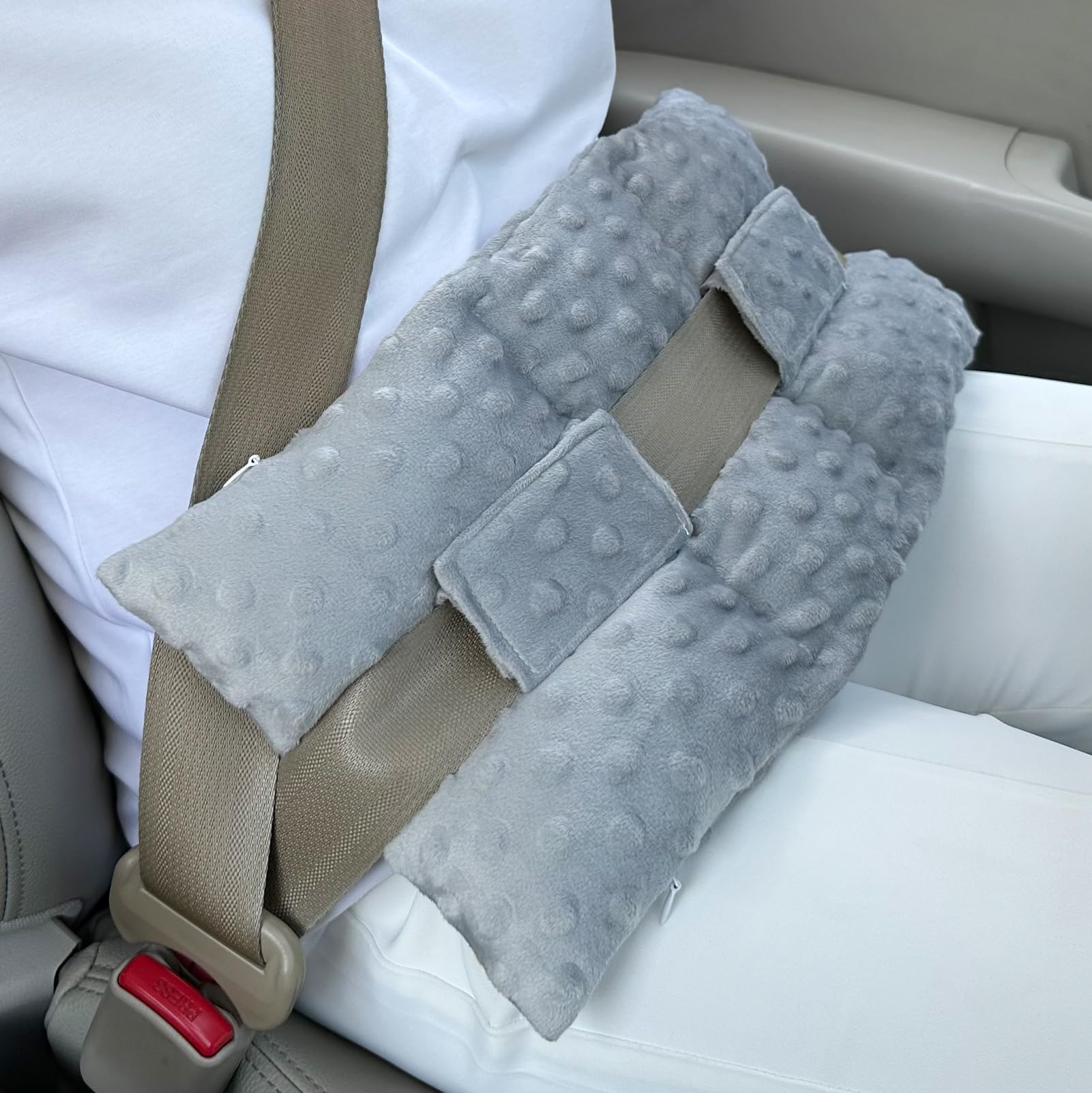 D. Cozy ostomy seatbelt pillow car setup cushions the stoma area during drives.