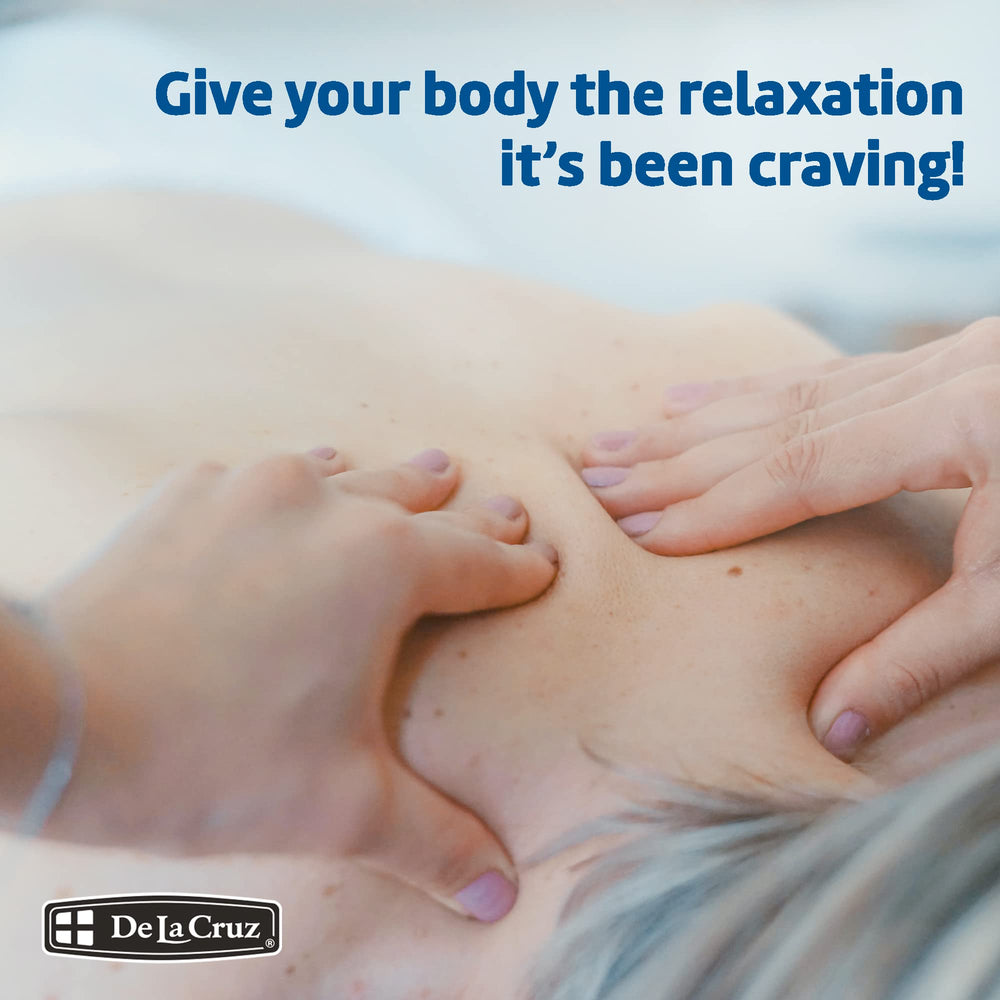 Hands apply De La Cruz Soothing Balsam using the pump for massage.