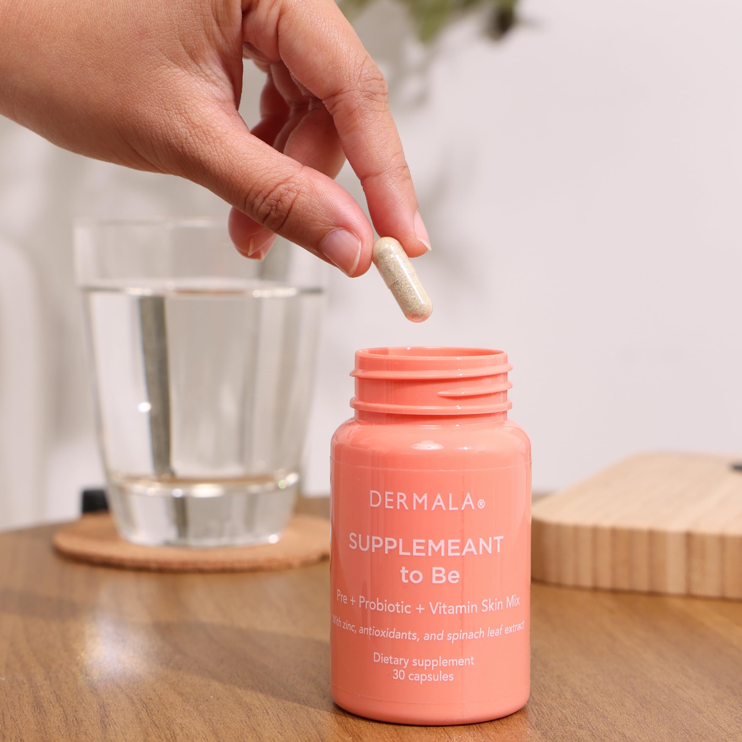 Dermala FOBO Supplemeant glass of water with pill for everyday use.