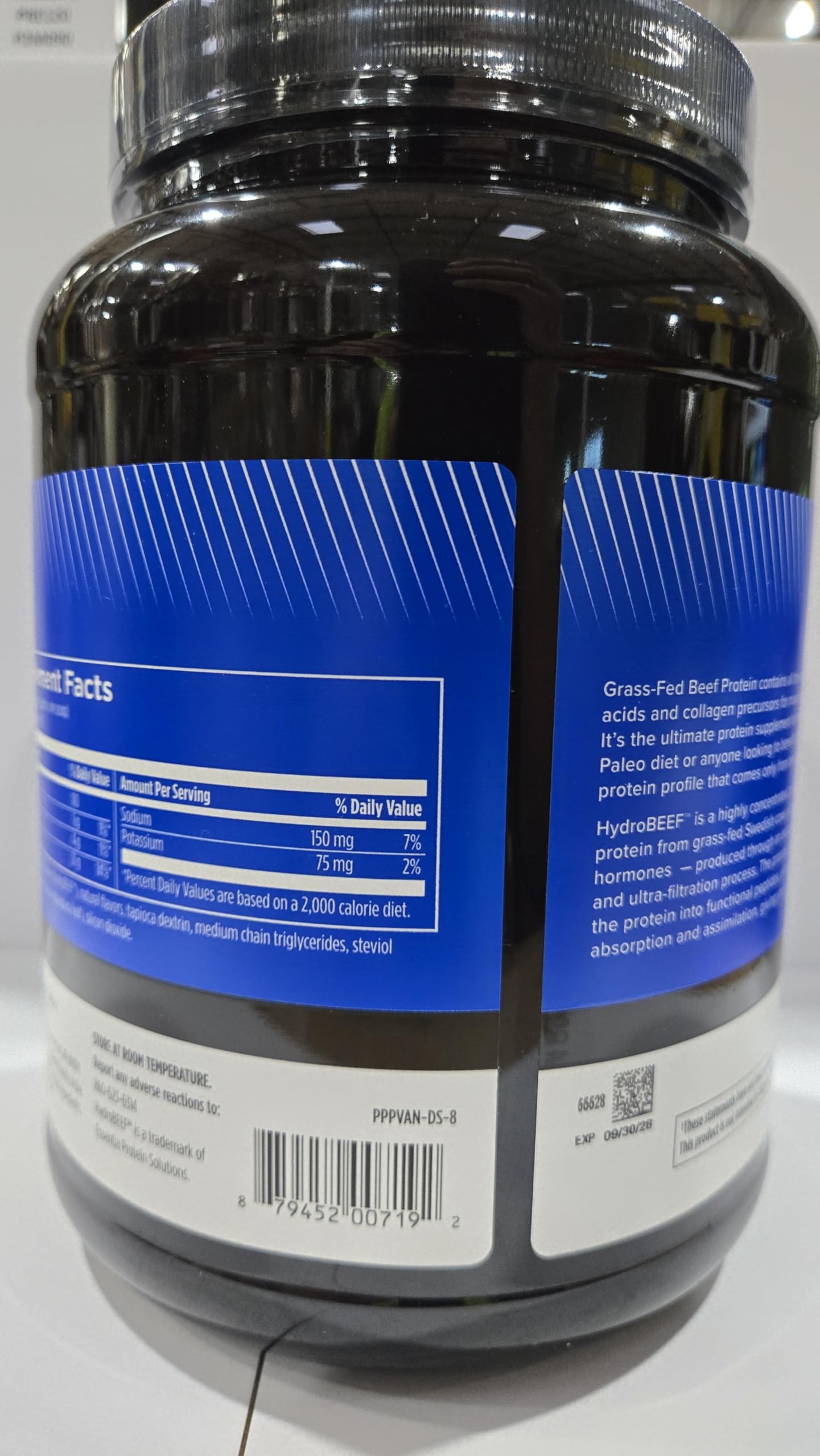 Designs for Sport chocolate flavor beef protein powder scoop close-up.