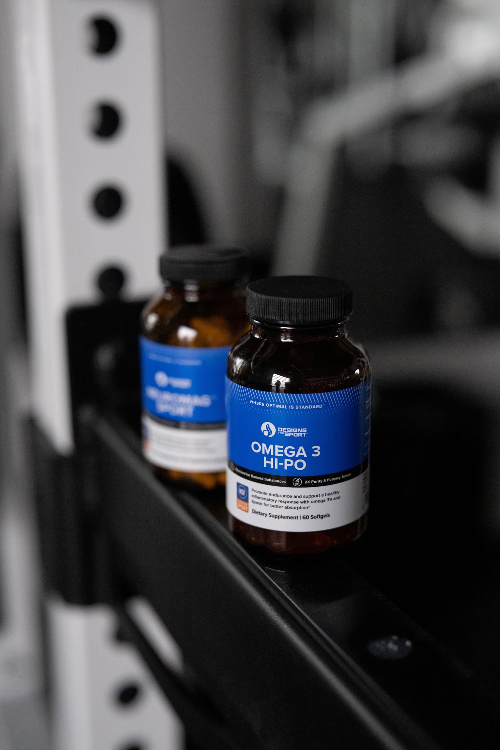 Close-up of Designs for Sport HI-PO softgels showing smooth capsules