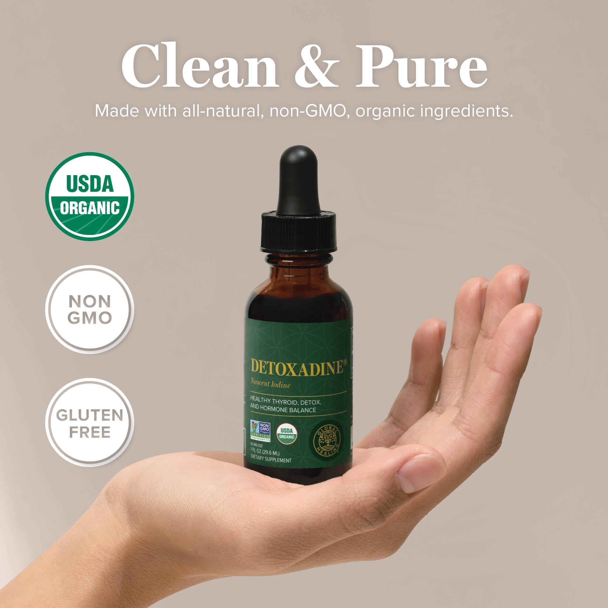 Hand holding Detoxadine bottle for convenient thyroid-friendly wellness routine