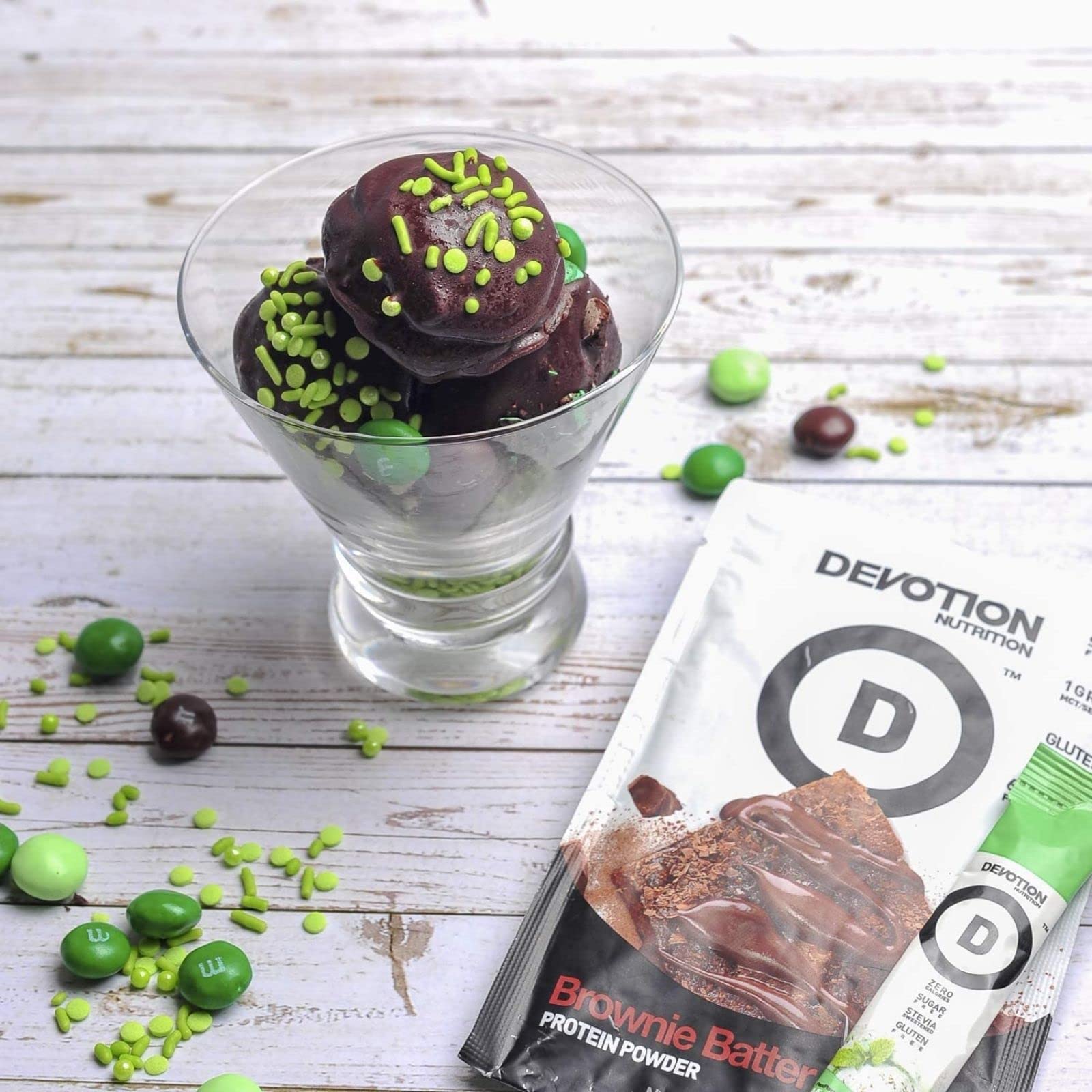 Devotion Nutrition Brownie Batter powder swirling in a blender for a smoothie.
