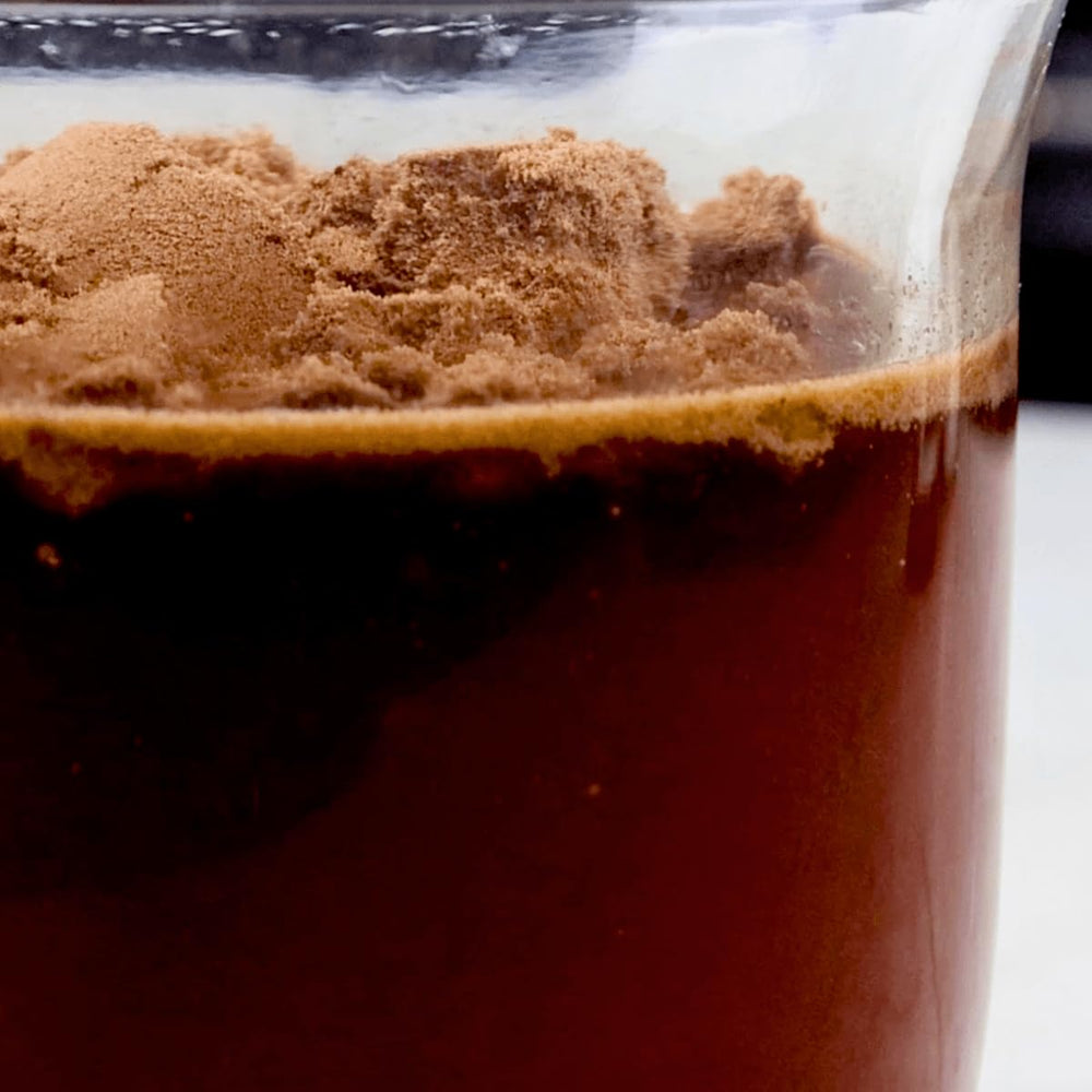 Divine Health Keto Zone MCT Dutch Chocolate serving scoop resting on powder