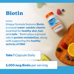 Biotin capsules arranged beside a hairbrush to imply hair, skin, and nails benefits.