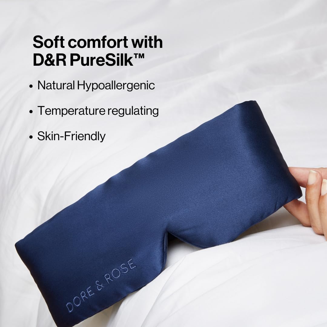 Dore and Rose Deep Sleep Mask with adjustable strap on bed