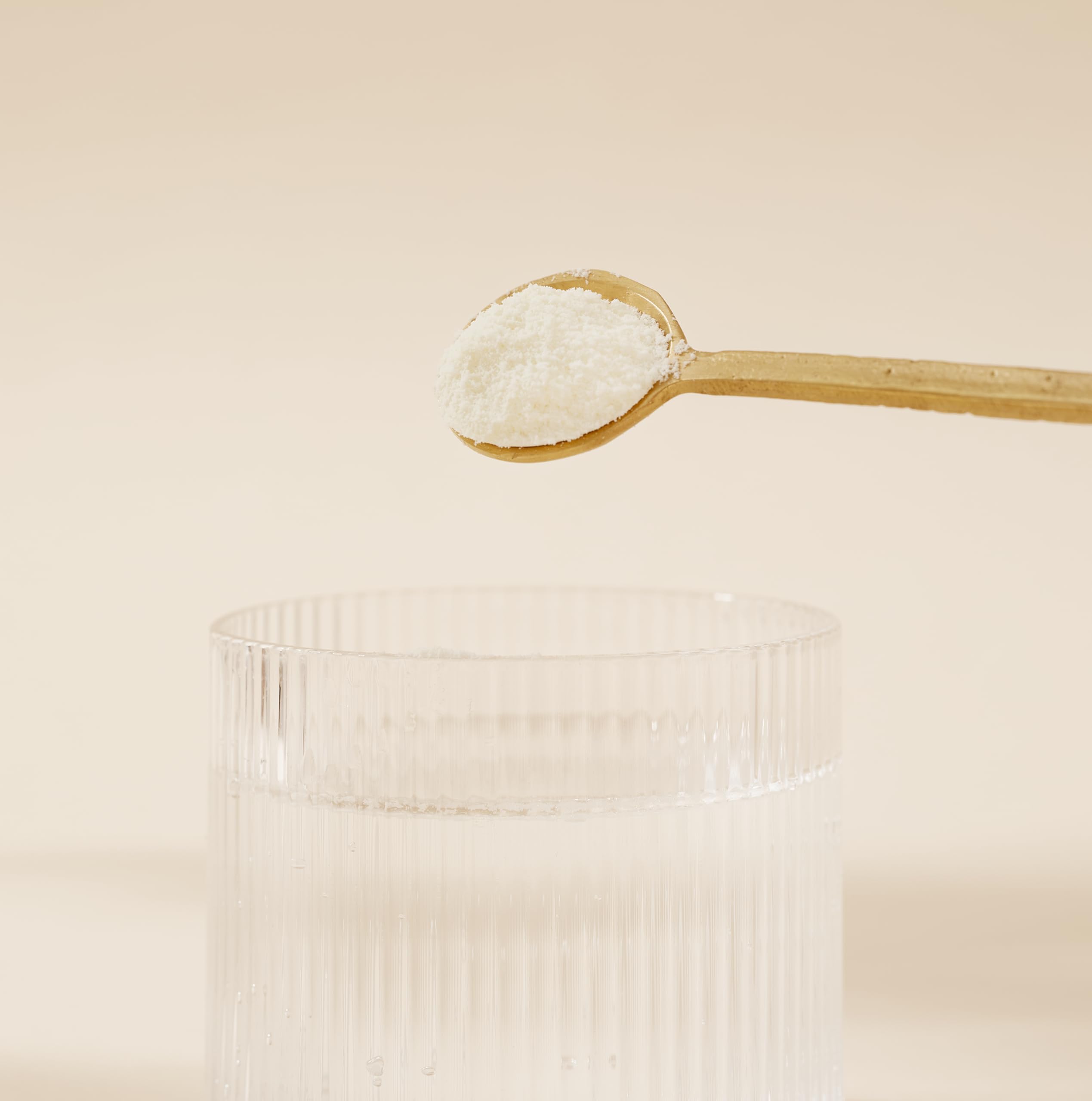 DOSE & CO. Pure Collagen on kitchen counter with glass of water