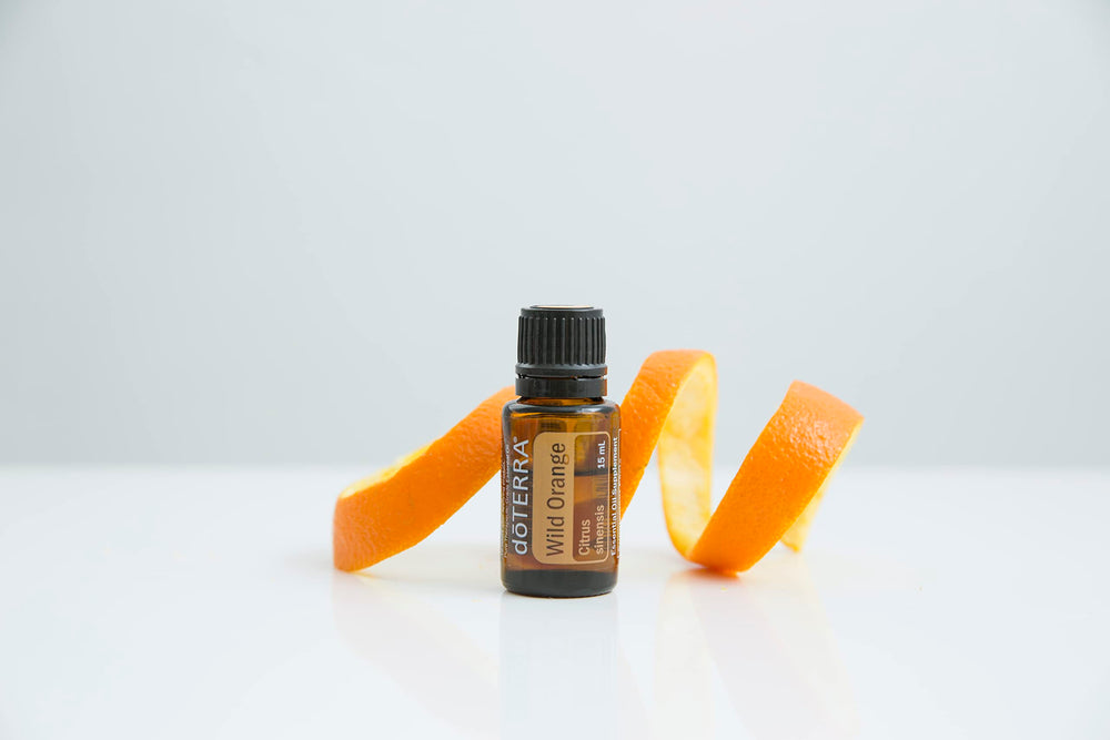 doTERRA Wild Orange oil diffuser releasing a fresh, energizing scent in a living room